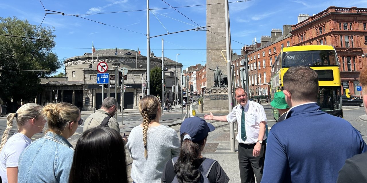 man pointing at monument